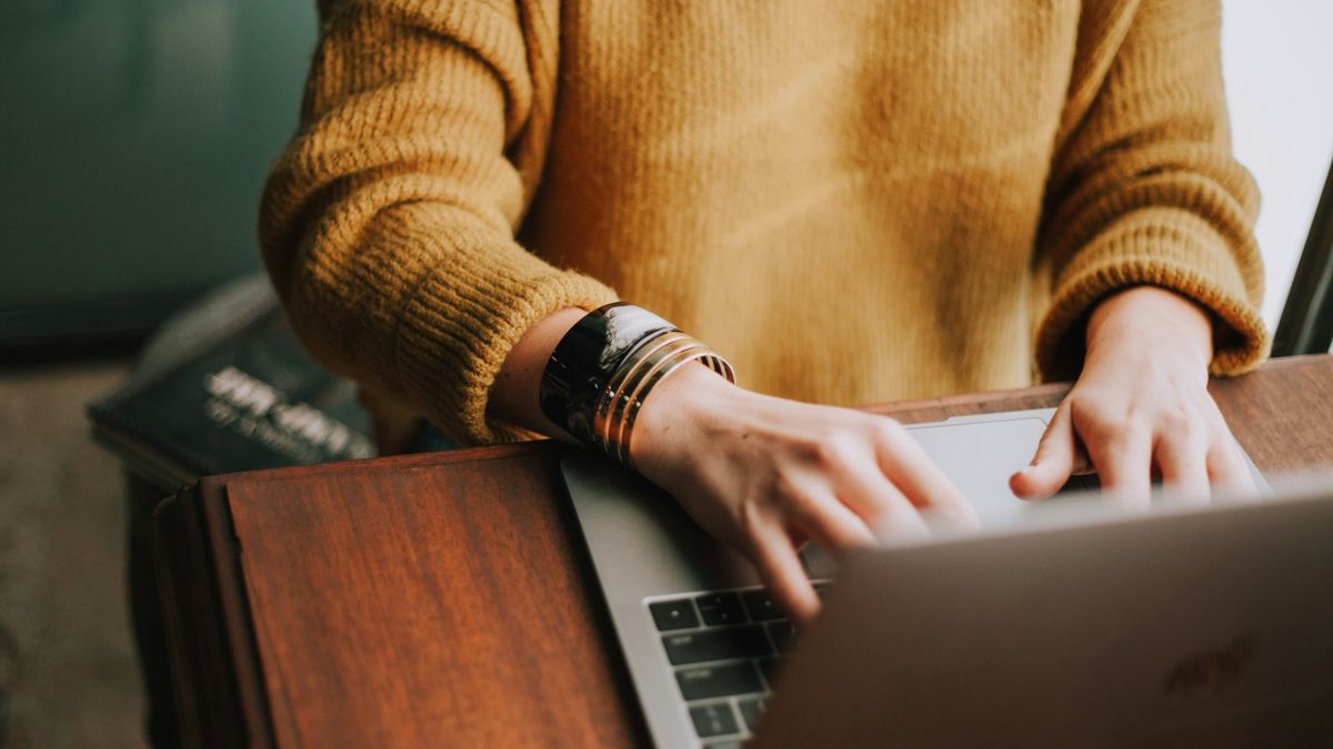 A woman typing on her laptop.